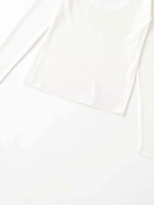 Detailed close-up of white ribbed knit fabric and low round neckline for women