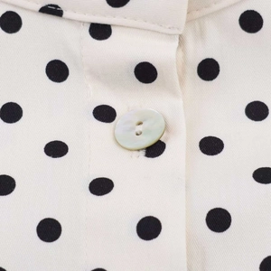 Detail of vintage polka dot shirt showing pearlescent button and fabric texture
