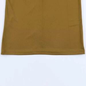 Detail of the double-needle stitched hem on ginger yellow knit dress fabric