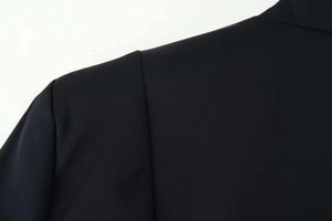 Detail of premium black twill fabric and reinforced shoulder stitching on the jacket