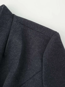 Detail view of charcoal wool blend fabric showing shoulder seam and collar texture