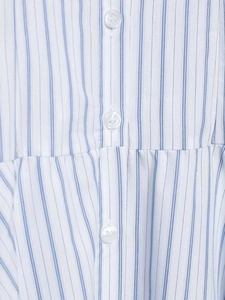 Macro detail of blue and white striped fabric with white buttons and precise stitching