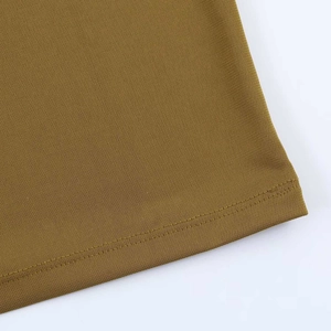 Detailed close-up of olive green dress hem showing professional double-needle stitching
