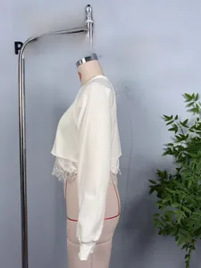 Detail of white cropped sweatshirt featuring exquisite lace hem splicing on a mannequin