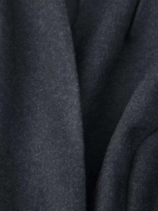 Detailed macro view of dark grey wool blend fabric showing thick texture and fibers