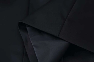 Detailed close-up showing black twill fabric texture and smooth matching inner lining