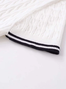 Close-up of white cable knit short sleeve shirt with black ribbed trim edges