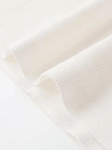 Close-up detail of white ribbed knit fabric texture with soft elastic vertical pattern
