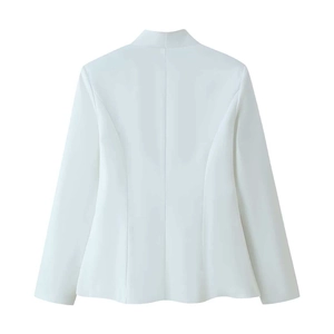 Detail view of the back seams and tailored waistline of a white women's blazer