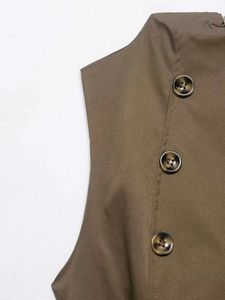 Detail of olive brown vest with marble pattern buttons and fine twill fabric texture