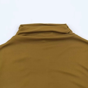 Detail of high neck draping on mustard yellow knit dress with fine elastic fabric