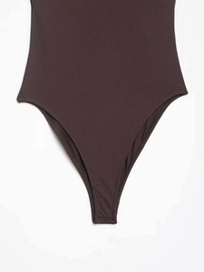 Detailed close-up of dark brown high-cut bodysuit with premium knit fabric texture