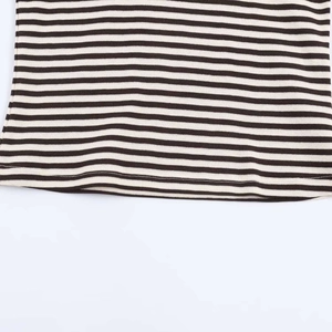 Detail of knit fabric texture and hem stitching on a black and white striped t-shirt