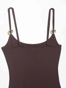 Detail of dark brown bodysuit with slim straps and decorative gold metal buckle rings
