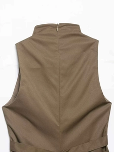 Detail of khaki sleeveless vest featuring high collar with a back invisible zipper