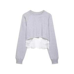 Detail of grey sweatshirt showing the delicate white lace trim and layered hem design