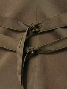 Detail of waist design with double-breasted buttons and ties on the olive vest