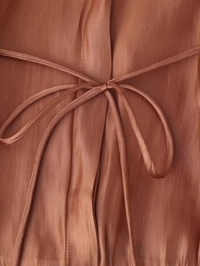 Close-up of brown Tencel shirt with silk-like vertical texture and drawstring detail