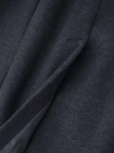 Detail of charcoal grey wool blend coat showing high-quality fabric texture and inner lining