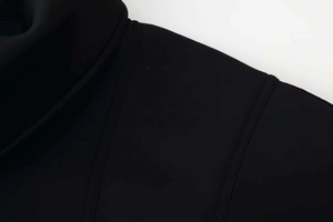 Detail of double-needle stitching on the shoulder seam of a black stand collar jacket