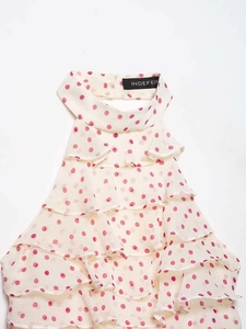Detailed view of ruffle halter top featuring pink polka dots on white chiffon fabric