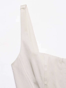 Close-up of beige summer dress showing twill fabric texture and princess seam details