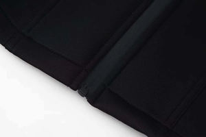 Detailed close-up of zipper seam and high-density neoprene fabric on black jacket