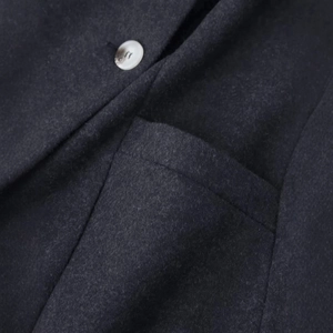 Deep charcoal wool blend coat featuring marble pattern button and clean pocket detail