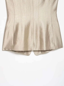 Detail of champagne gold satin fabric with elegant waist stitching and metallic finish