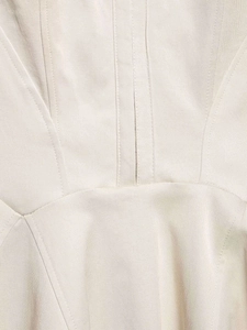 Close-up of beige summer strap dress showing structured stitching and premium fabric texture