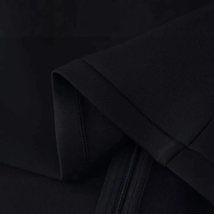 Minimalist black cropped jacket with stand collar and hidden zipper detail
