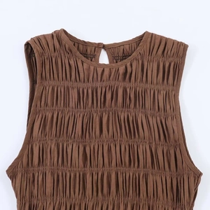 Dark brown sleeveless top featuring smocked pleats and a round neckline with a back button
