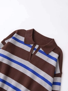 Close-up of the retro V-neck polo collar and striped knit fabric on a loose sweater