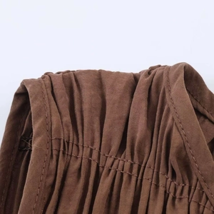Detail of elastic smocking stitch and neat double needle seams on brown midi dress