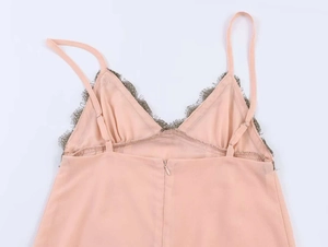 Close-up of pink dress showing the contrast lace trim and invisible back zipper detail