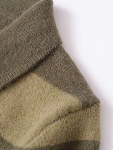 Macro detail of high-quality olive and khaki patchwork knit fabric with soft texture