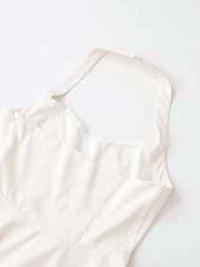 Detailed side view of cream halter dress showing seamless invisible zipper and fabric texture