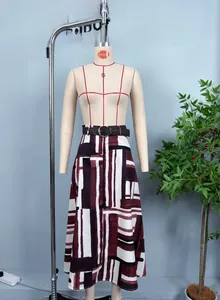 Detail of red and black geometric pattern maxi skirt with a woven belt on a hanger