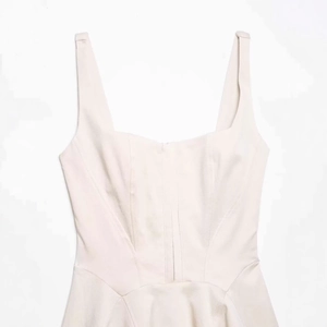 Slim fit light apricot sleeveless dress with square neckline and structured seam lines