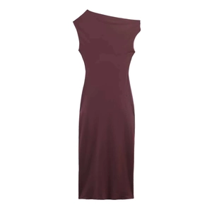 Close-up of asymmetrical shoulder design and ruched detail on dark wine red dress