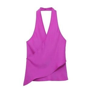 Close-up of fuchsia halter neck top featuring asymmetric hem and silk satin texture