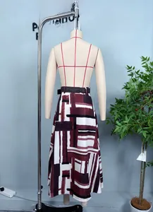 Detail view of high waist A-line skirt with burgundy geometric print and black belt