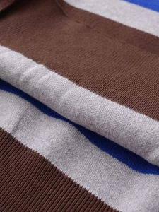 Close-up of the V-neck knit sweater showing brown, grey, and blue striped fabric texture