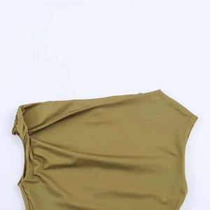 Detail view of olive green asymmetric dress with shoulder knot and pleated texture