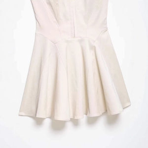 Minimalist apricot A-line camisole dress featuring elegant pleated skirt detail