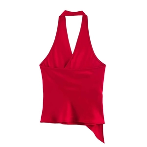 Macro detail of red satin halter neck top with asymmetric draped hem and glossy silk texture