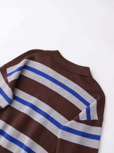 Close-up detail of soft ribbed neckline on a brown and grey striped knit sweater