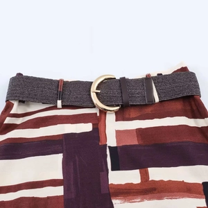 Women's vintage geometric print skirt with a brown braided belt and gold buckle details