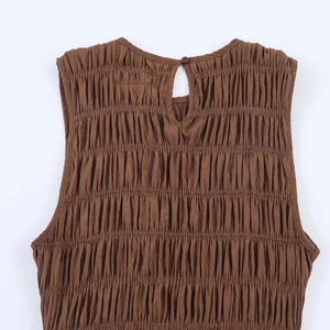Detail of the brown ruched fabric with back neck button and teardrop cutout design