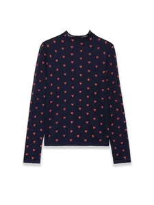 Detailed close-up of dark blue knit top featuring vibrant red heart patterns